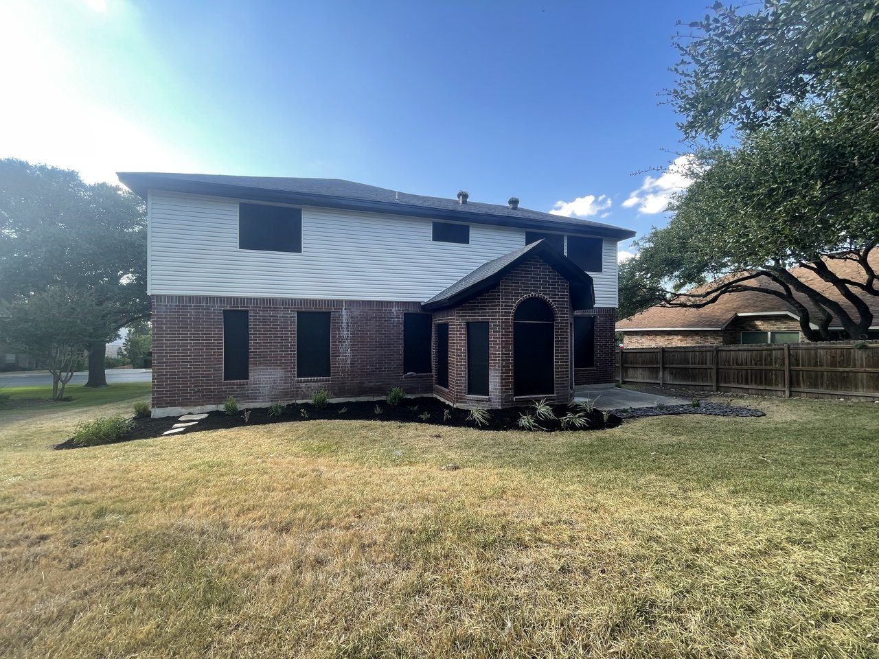 Two-story home exterior with complete solar screen installation